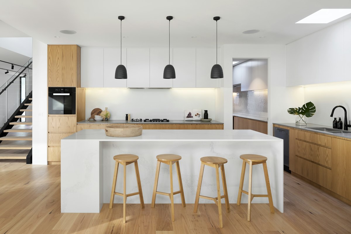 Realistic photograph of custom kitchen marble waterfall island with spatial dimension markers.